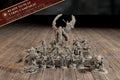 Group photo of all 20 painted-ready miniatures from the The Dire End campaign bundle, with a Ready to Play banner listing miniatures, campaign book, character sheets, and battle sheets.
