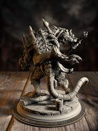 Rear view of the Rat King miniature showing its bristling fur, banner-hung back, and coiled tail winding across the base