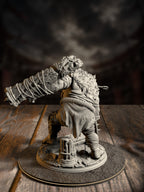 Rear view of the ettin brute miniature showing its hunched, muscular back and the club raised over a cracked stone plinth